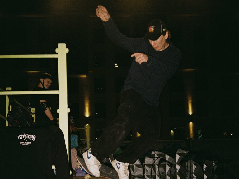 Rinat riding a skatepark ramp at night.