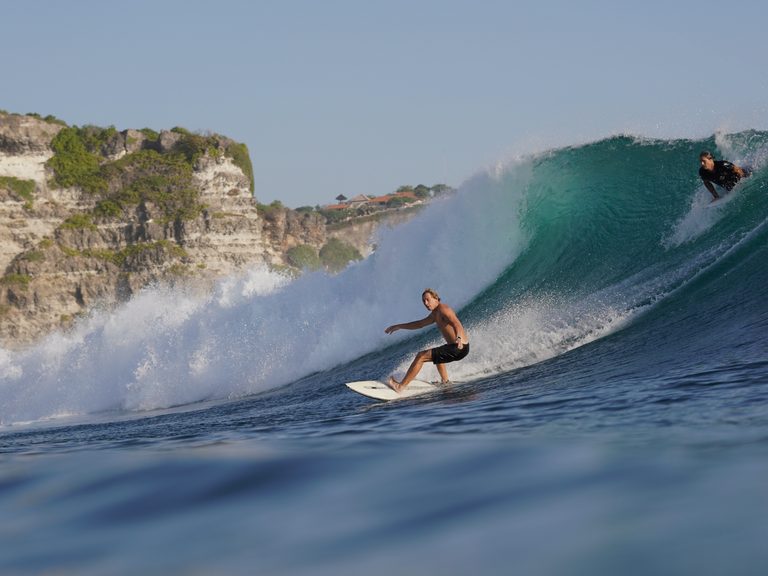 Rinat riding the face of a breaking wave.